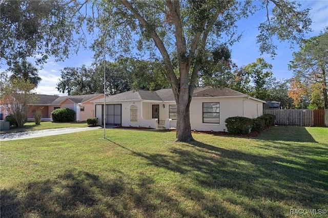 ranch-style home featuring a front yard