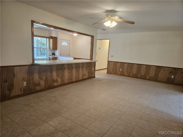 7781 N Lazy Trl, Crystal River, FL 34428 - empty room with a wainscoted wall, a ceiling fan, and wooden walls