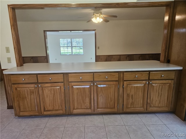 7781 N Lazy Trl, Crystal River, FL 34428 - kitchen with brown cabinets, light countertops, a ceiling fan, and wainscoting