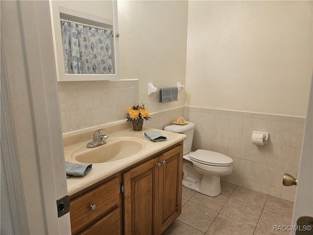 7781 N Lazy Trl, Crystal River, FL 34428 - bathroom with vanity, toilet, tile walls, tile patterned floors, and a wainscoted wall