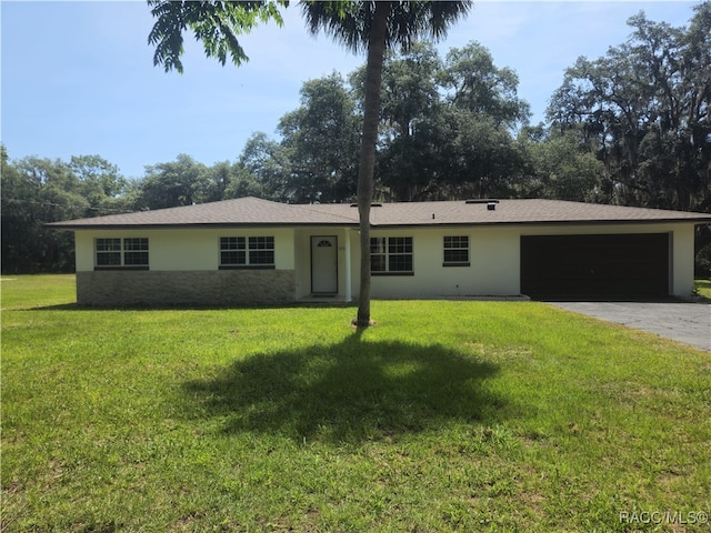 7781 N Lazy Trl, Crystal River, FL 34428 - ranch-style home featuring an attached garage, stucco siding, driveway, and a front yard