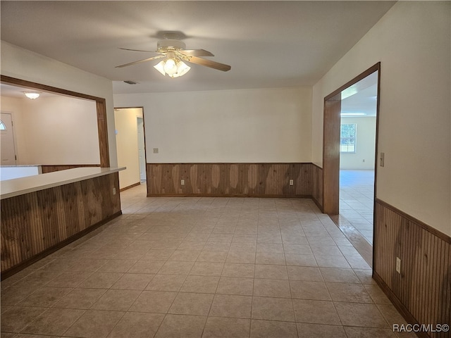 7781 N Lazy Trl, Crystal River, FL 34428 - unfurnished room featuring a wainscoted wall, ceiling fan, and wood walls