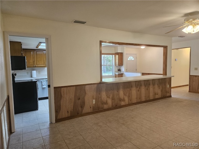 7781 N Lazy Trl, Crystal River, FL 34428 - kitchen with a ceiling fan, range with electric stovetop, light countertops, light tile patterned floors, and stainless steel dishwasher