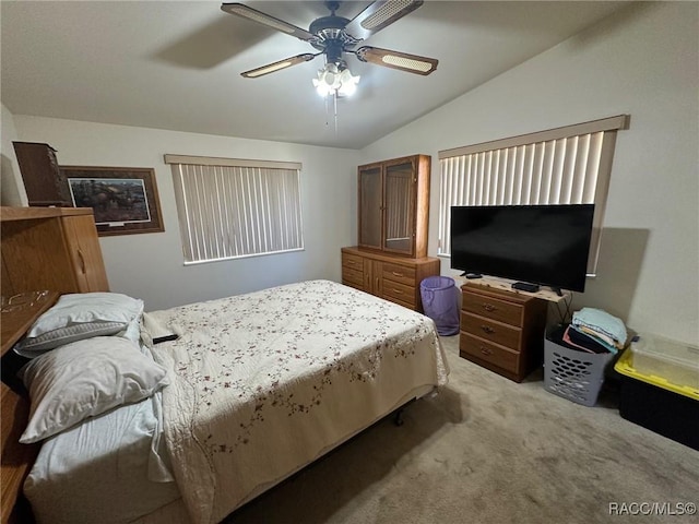 carpeted bedroom with lofted ceiling and a ceiling fan