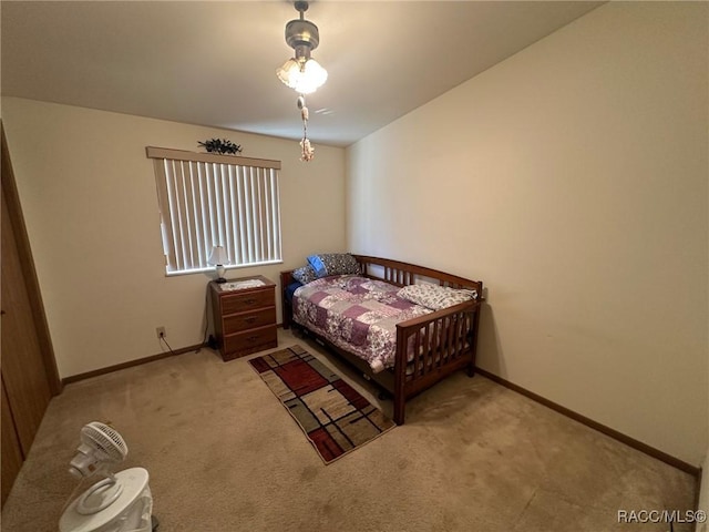 carpeted bedroom featuring baseboards