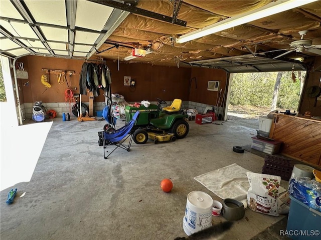 garage featuring an AC wall unit and a garage door opener