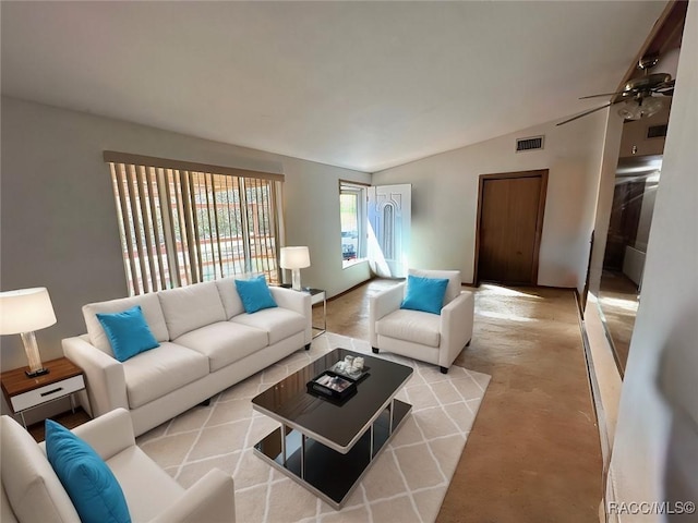 living room with vaulted ceiling, visible vents, and ceiling fan