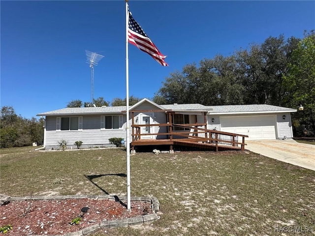 view of front facade with a garage, driveway, a wooden deck, and a front yard