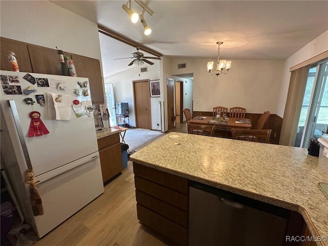 kitchen featuring vaulted ceiling, light wood-style flooring, light countertops, and freestanding refrigerator