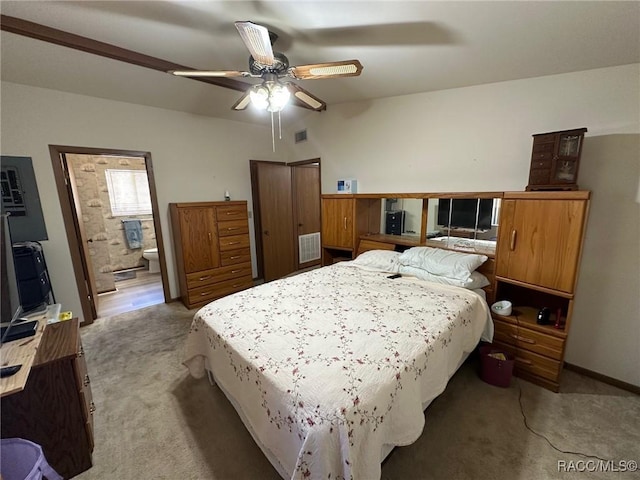 bedroom featuring light colored carpet, visible vents, a closet, and ceiling fan