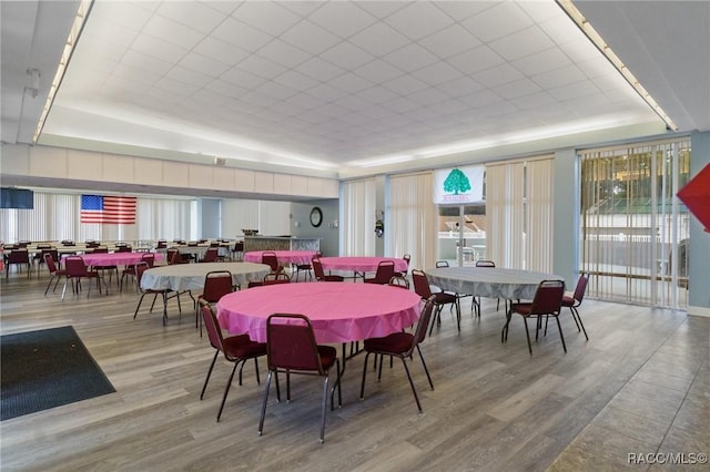 dining area featuring hardwood / wood-style flooring and a tray ceiling