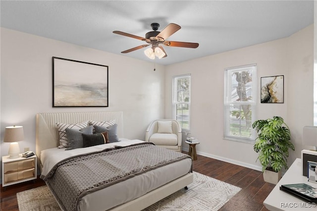 bedroom with ceiling fan and dark hardwood / wood-style floors