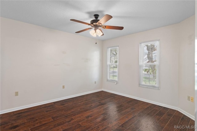 spare room with ceiling fan and dark hardwood / wood-style flooring