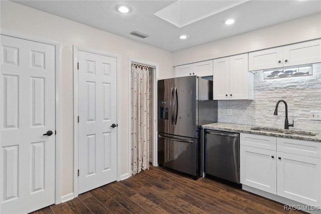 kitchen featuring sink, light stone countertops, white cabinets, and appliances with stainless steel finishes