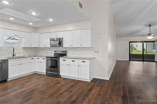 kitchen featuring light stone countertops, white cabinetry, appliances with stainless steel finishes, and sink