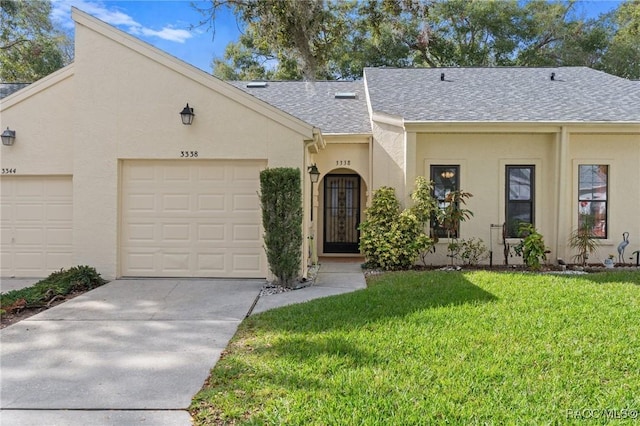 view of front facade with a garage and a front yard