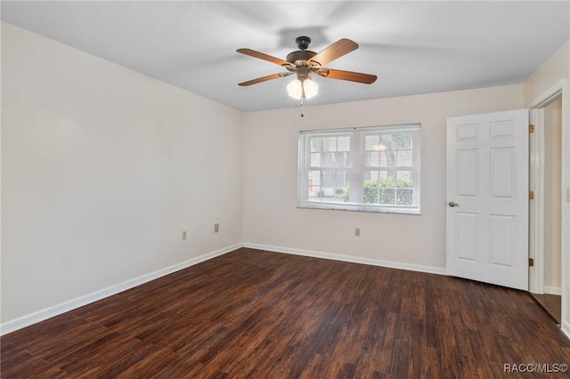 empty room with dark wood-type flooring and ceiling fan