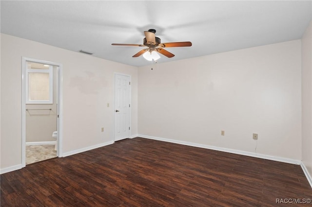 spare room featuring dark hardwood / wood-style floors and ceiling fan