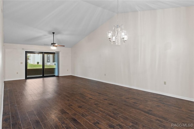 empty room featuring ceiling fan with notable chandelier, vaulted ceiling, and dark hardwood / wood-style floors