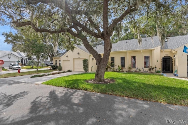 view of front of home featuring a garage and a front lawn