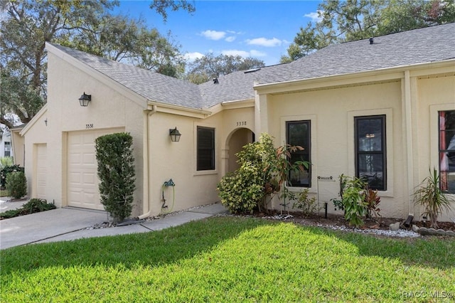 view of front of property featuring a garage and a front lawn