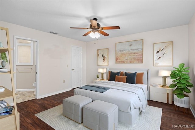 bedroom with dark hardwood / wood-style floors, connected bathroom, and ceiling fan