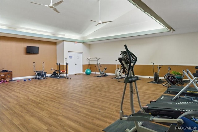 workout area with vaulted ceiling, hardwood / wood-style floors, and ceiling fan