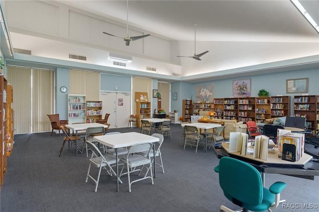 dining area featuring ceiling fan, carpet, and high vaulted ceiling