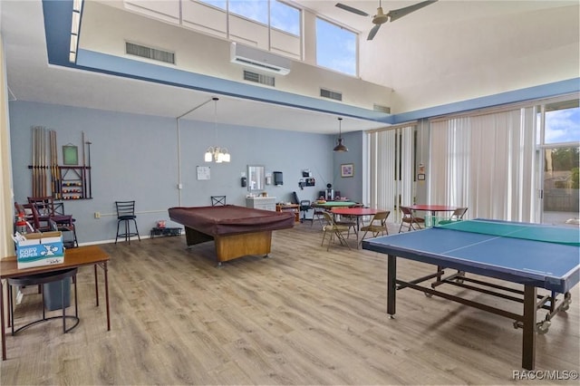 recreation room featuring hardwood / wood-style floors, pool table, ceiling fan, and a high ceiling