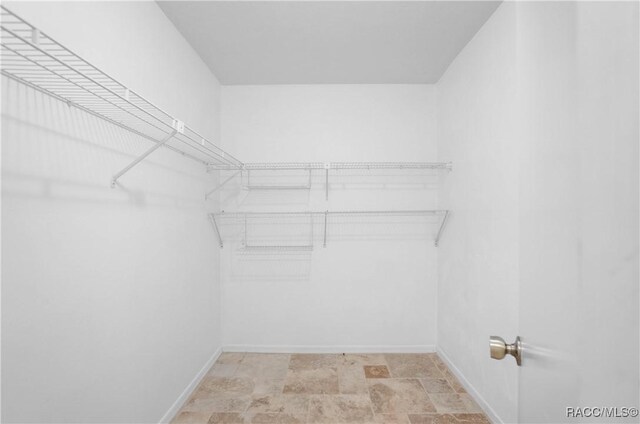 609 W Olympia St, Hernando, FL 34442 - walk in closet featuring stone finish floors