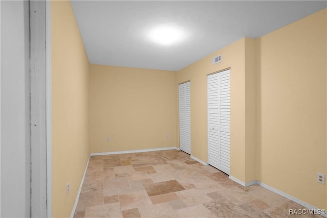 609 W Olympia St, Hernando, FL 34442 - unfurnished bedroom featuring stone finish floors and baseboards