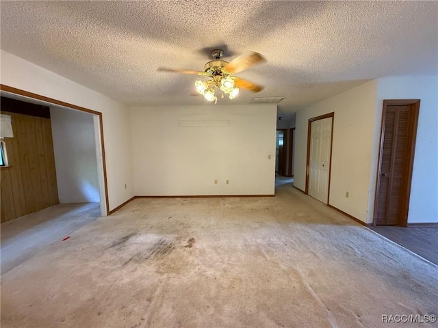 2098 W Deer Trail Ln, Lecanto, FL 34461 - empty room with ceiling fan, carpet, and a textured ceiling