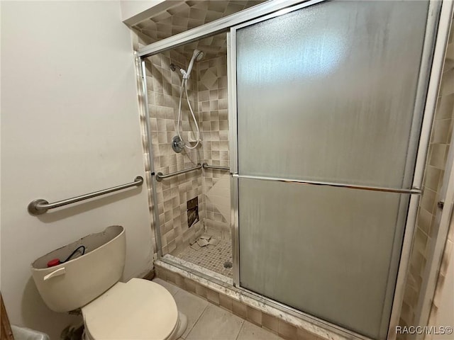 2098 W Deer Trail Ln, Lecanto, FL 34461 - bathroom featuring a shower stall, toilet, and tile patterned flooring