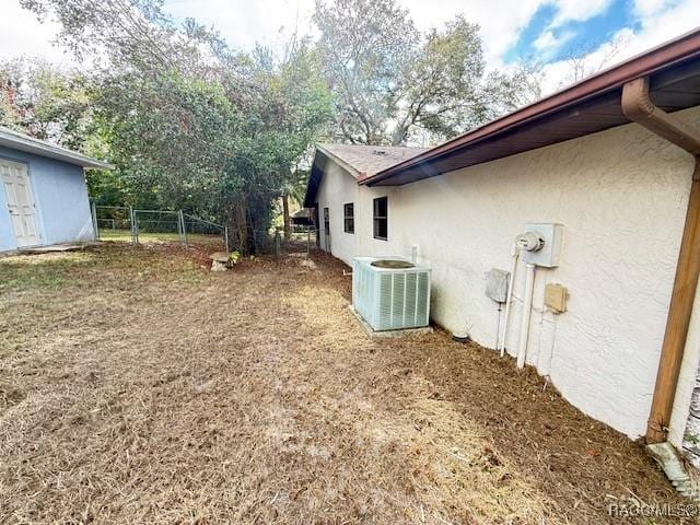 view of side of home featuring cooling unit