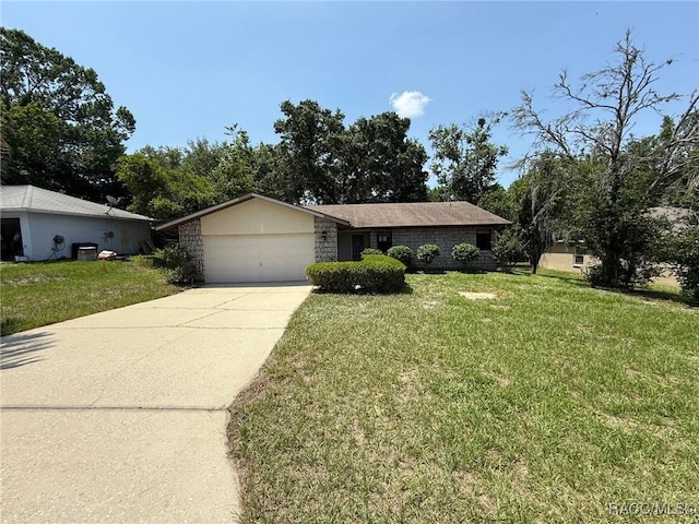 2098 W Deer Trail Ln, Lecanto, FL 34461 - view of front of house featuring an attached garage, a front yard, and driveway