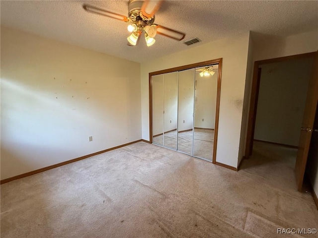 2098 W Deer Trail Ln, Lecanto, FL 34461 - unfurnished bedroom with carpet, a textured ceiling, a closet, and baseboards