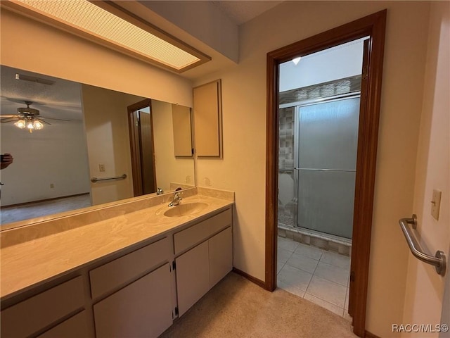 2098 W Deer Trail Ln, Lecanto, FL 34461 - full bathroom featuring vanity, a ceiling fan, an enclosed shower, tile patterned floors, and baseboards