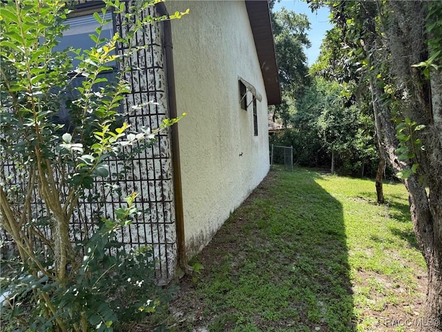 2098 W Deer Trail Ln, Lecanto, FL 34461 - view of side of property with stucco siding and a lawn