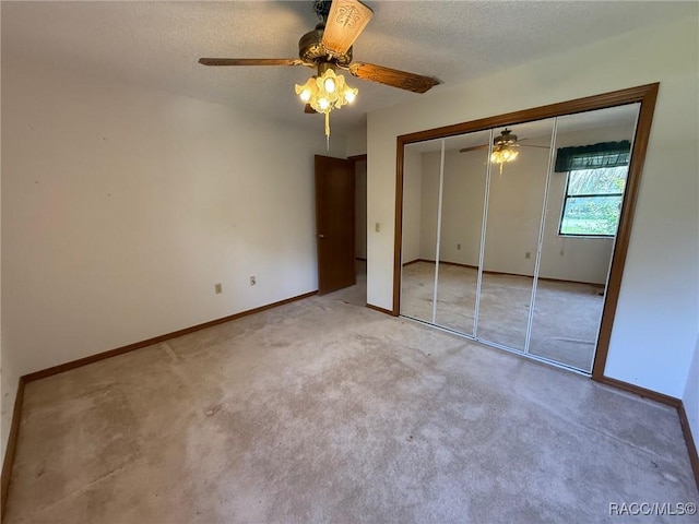 2098 W Deer Trail Ln, Lecanto, FL 34461 - unfurnished bedroom featuring a ceiling fan, baseboards, carpet flooring, a textured ceiling, and a closet
