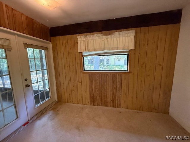 2098 W Deer Trail Ln, Lecanto, FL 34461 - spare room featuring wooden walls, carpet floors, and french doors