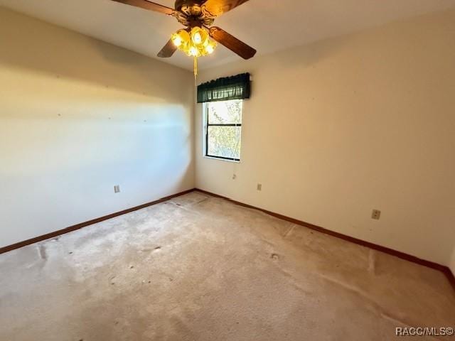 carpeted empty room featuring ceiling fan