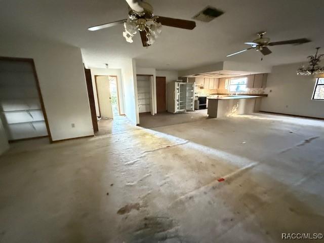 unfurnished living room with ceiling fan and plenty of natural light