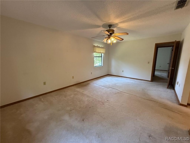 2098 W Deer Trail Ln, Lecanto, FL 34461 - unfurnished room with light colored carpet, ceiling fan, baseboards, and a textured ceiling