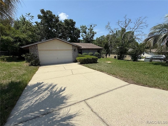 2098 W Deer Trail Ln, Lecanto, FL 34461 - view of front of house with a front yard, concrete driveway, and an attached garage