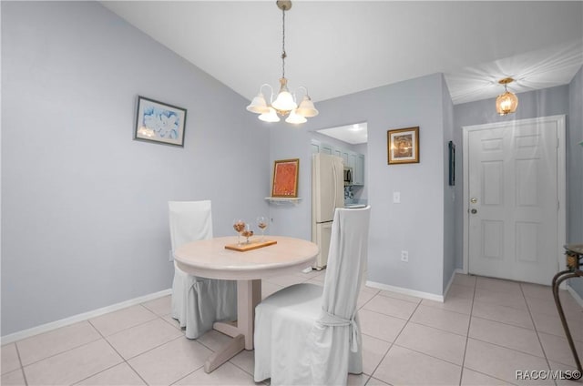 dining space featuring light tile patterned floors, baseboards, lofted ceiling, and a notable chandelier