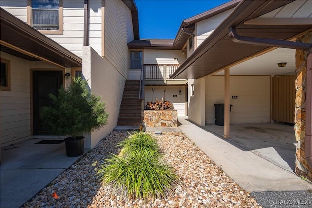 exterior space featuring stairs and stucco siding