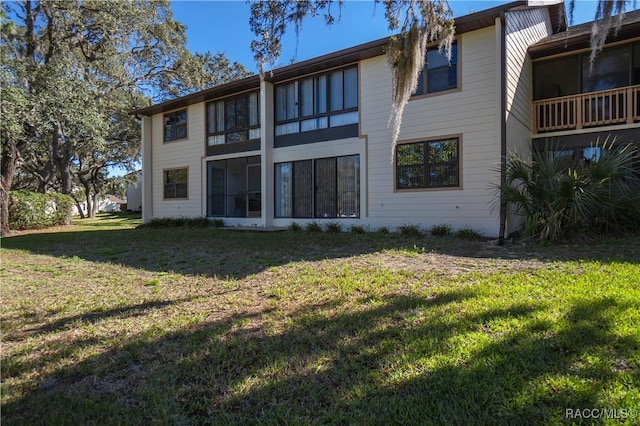 rear view of house with a lawn