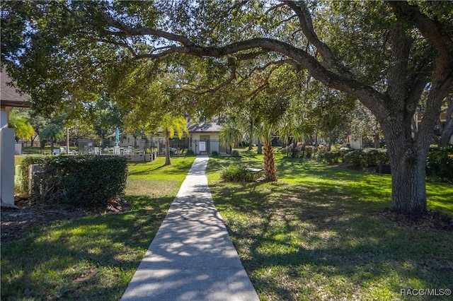 view of community with a lawn and fence