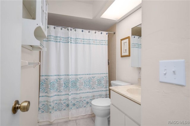 bathroom with toilet, tile patterned flooring, a shower with shower curtain, and vanity