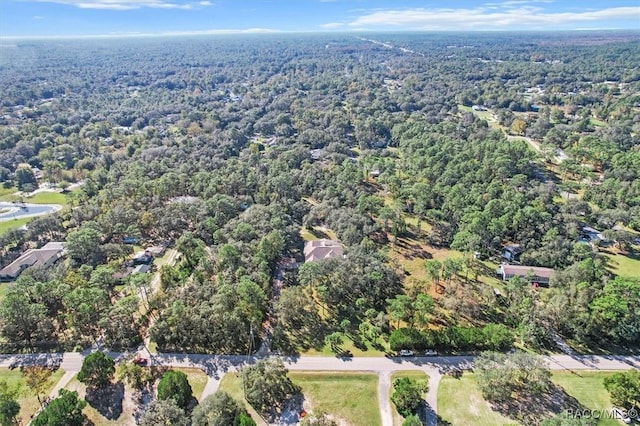 drone / aerial view with a wooded view